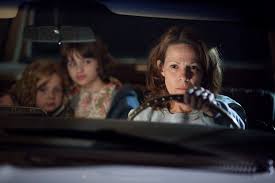 Carolyn driving away with two girls